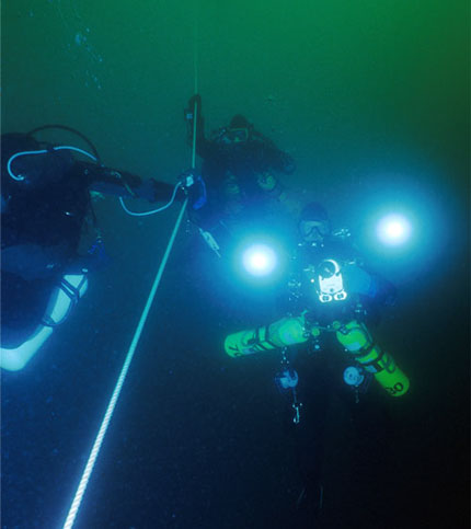 Divers descending to video a shipwreck